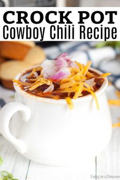 crock pot cowboy chili recipe in a white bowl with cheese and onions on top