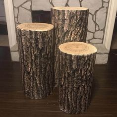 three logs sitting on top of a wooden floor