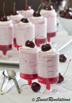 small desserts with cherries and whipped cream on them