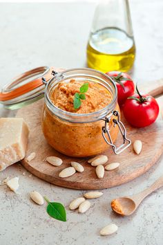 a jar filled with food sitting on top of a wooden cutting board