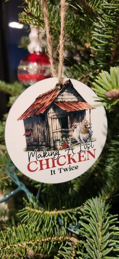 an ornament hanging from a christmas tree that says making a nest chicken it's twice