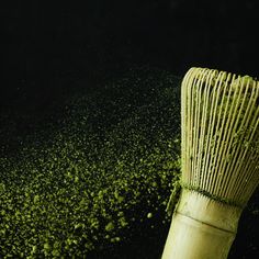 a close up of a bamboo brush with green stuff on the top and bottom of it