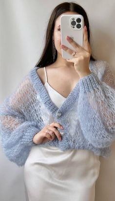 Mohair cardigan with buttons will make your image feminine, delicate and unique! The buttons in the shape of hearts, delicate to the touch thanks to the silk in the composition, will complete your look. Those voluminous sleeves are so appealing 😍  Hand-knitted mohair cardigan is made of mohair yarn with silk (70% mohair, 30% silk). Color : blue cardigan  Size : M/L Oversize Cardigan Cardigan length - 60 cm Suitable for chest up to 110 cm  *The height of the model on the photo is 167 cm.  If you need a cardigan in a different color or size, write me and I will knit it for you :) To make the cardigan last as long as possible, there are care recommendations: Hand wash at 30 o C / 86 oF, with wool conditioner, you can also use hair shampoo. Do not dry in the dryer. Do not bleach. Do not wring Mohair Cardigan For Layering, Crochet Mohair Cardigan, Winter Mohair Cardigan With Soft Texture, Soft Knit Mohair Cardigan, Luxury Hand Knitted Mohair Cardigan, Cozy Mohair Knitted Cardigan, Luxury Mohair Soft Knit Cardigan, Bridal Cardigan, Cardigan With Buttons