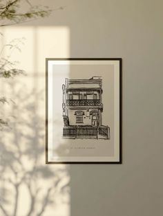 a black and white photo hanging on the wall next to a vase filled with flowers