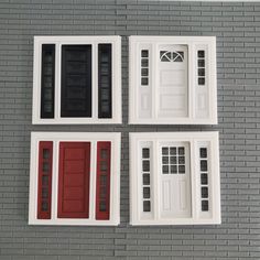 four windows with red and white trim on a gray brick wall next to each other