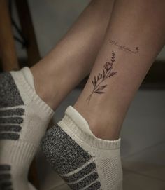 a woman's legs with a tattoo on her left leg and the word love written in cursive writing