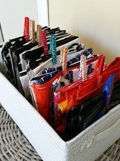 a basket filled with lots of purses on top of a table