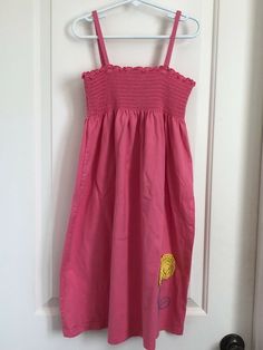 ** the pink is brighter than the photos show This dress is in very good used condition.   Armpit to armpit measures approximately 10.5  inches. The length of the dress, from the top of the shoulder, measures approximately 29 inches. We accept payments through Pay Pal only. Please pay within three days of purchase.  Unpaid item assistance will be turned on after the third day if payment has not been received. We accept returns. The item must be returned in the same condition that we sent it. If t Pink Sleeveless Cotton Dress For The Beach, Pink Sleeveless Cotton Beach Dress, Pink Sleeveless Cotton Dress For Beach, Casual Sleeveless Dress With Floral Applique, Pink Cotton Sleeveless Sundress, Pink Sleeveless Dress, Flower Applique, Hanna Andersson, Yellow Flower