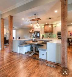 an open kitchen and dining room with wood floors