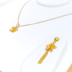 Crafted from 22k yellow gold, this modest pendant set weighs 3.8 grams and features an elegantly understated floral design. The pendant is 0.75 inches long, offering a subtle touch of beauty, while the matching earrings are longer at 1.75 inches, providing a graceful dangle. Each earring is equipped with a push-back post for easy and secure wear. This three-piece set perfectly captures the essence of simplicity and elegance, making it suitable for both everyday wear and special occasions. The ha Delicate Gold Jewelry, Bridal Jewelry Necklace, Precious Stones Rings, Diamond Pendant Sets, Modern Bracelets, Mens Gold Rings, Fancy Necklace, Fancy Rings, Diamond Necklace Set