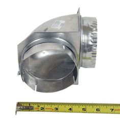 a metal object with a ruler next to it and a measuring tape on the side