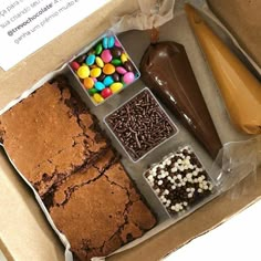 a box filled with brownies, marshmallows, chocolate and sprinkles