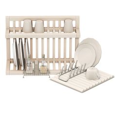 a dish rack with dishes and utensils in it next to a set of plates