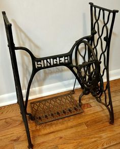 an old sewing machine sitting on top of a wooden floor