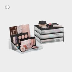 three drawers with cosmetics and makeup products in them on a white background, the top one is empty