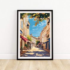 a framed poster with the words montpellier on it in front of a white wall