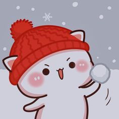 a white cat wearing a red hat and holding a snowball in its paws while standing in the snow