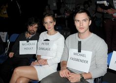 three people sitting next to each other with signs on their backs reading michael fassbener, peter hoult and michael fassbender