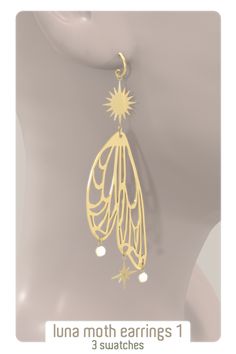 a pair of earrings with stars hanging from it's back end, on top of a mannequin head