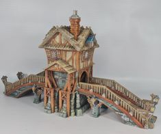 a small wooden house with a bridge and animals