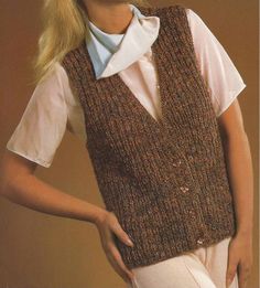 a woman wearing a brown vest and white shirt with her hands on her hips, standing in front of a beige background