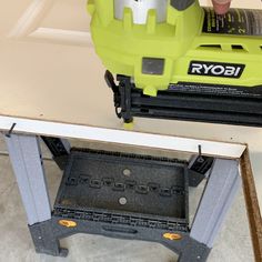 a person using a router to cut up a piece of wood on a table