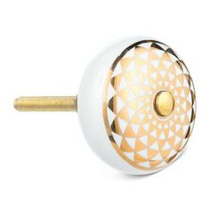 a white and gold door knob with an intricate design on the front, side and back