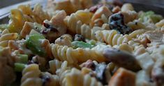 a pasta salad with chicken, broccoli and raisins