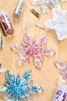 some glittered snowflakes are laying on a table