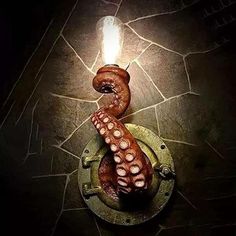 an octopus is sitting on top of a light