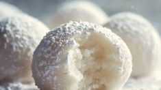 powdered sugar covered doughnuts are on a plate and ready to be eaten