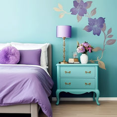 a blue and purple bedroom with flowers painted on the wall, bedding and nightstand