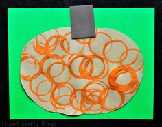 a paper plate with orange circles on it and a piece of tape sticking out of the middle