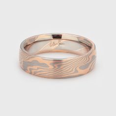 a wedding ring made out of wood with an engraved design on the inside and outside