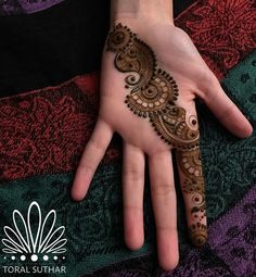 a woman's hand is decorated with hennap and intricate designs on it