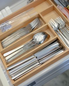 a drawer with silverware and utensils in it