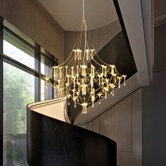 a chandelier hanging from the side of a staircase