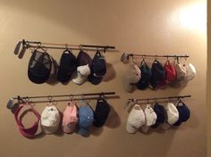 there are many hats hanging on the wall