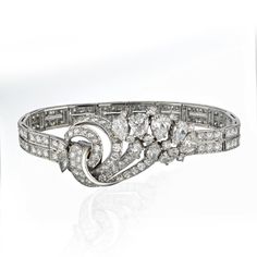 Indulge in the luxury of a bygone era with this exquisite Platinum Diamond Bracelet, adorned with a mesmerizing array of 156 diamonds totaling 13.25 carats. The vintage cut round, old cut marquise, and old cut pear diamonds, with their G-H color and VS1-VS2 clarity, create a dazzling symphony of brilliance. Each gem tells a tale of timeless elegance, signed by the prestigious Mellerio Paris. Elevate your style and make a statement that transcends time. Luxury Vintage Bracelets With Diamond Hour Markers, Luxury Vintage Diamond Bracelet Gift, Luxury Vintage Diamond Bracelet For Gift, French Bracelet, Retro Bracelet, Jewellery Indian, Bridal Jewellery Indian, Bygone Era, Pear Diamond