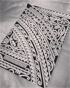 a black and white photo of an intricately designed piece of art on a sheet of paper