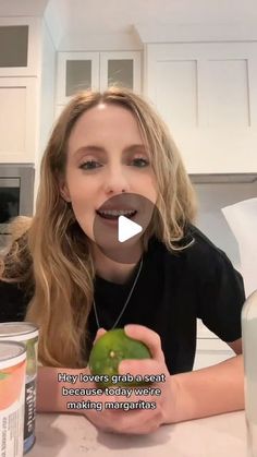 a woman sitting at a kitchen table with an apple in front of her and the caption says, hey livers are present because today we's making margaritas