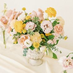 there are many different flowers in the vases on the table together and one is yellow