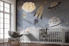 a baby's room decorated with space themed wallpapers and a crib