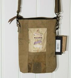 a brown bag hanging from the side of a white door with a tag on it