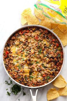 a casserole dish with tortilla chips on the side