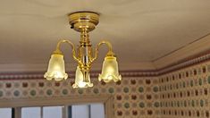 a chandelier hanging from the ceiling in a room with wall papered walls