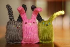 three knitted rabbits sitting next to each other