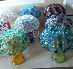 several different colored vases sitting on top of a counter