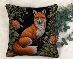 a pillow with a fox and flowers on it