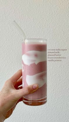 a hand holding a glass with liquid in it and the words coconut milk yogurt almond milk